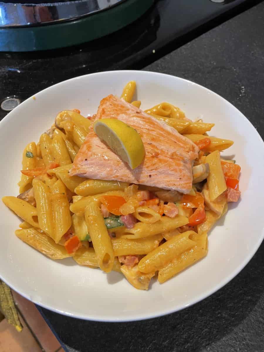 Simply-fried-salmon-on-a-penne-pasta-salad-with-bacon-courgette-and-pepper-scaled